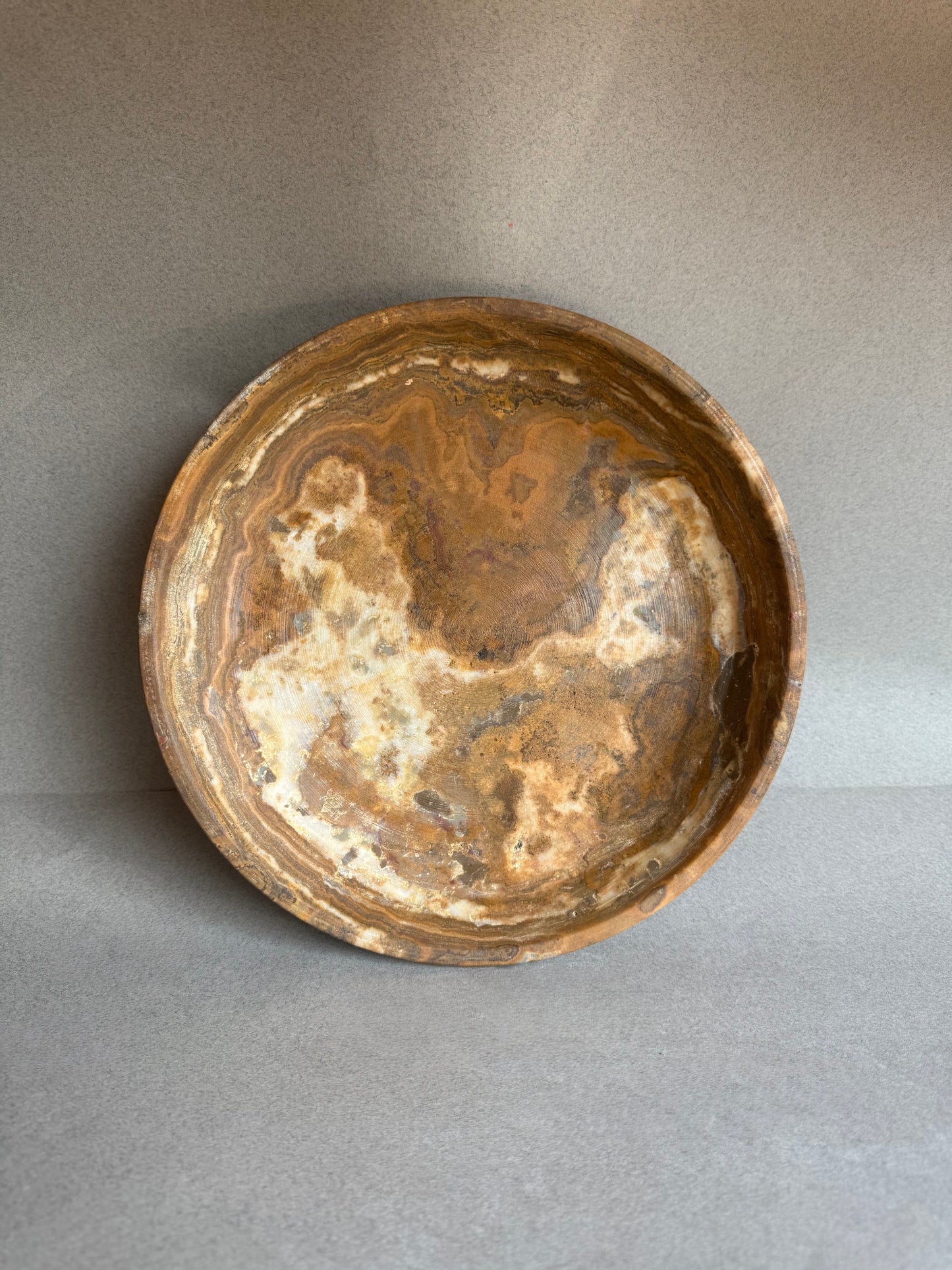 Brown stone bowl on a gray background