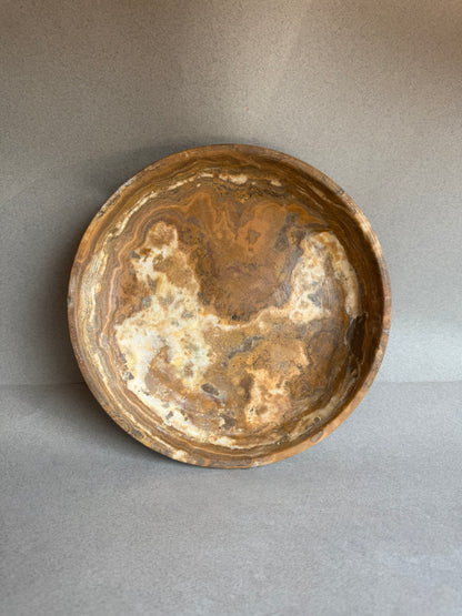 Brown stone bowl on a gray background