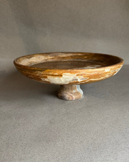 Brown ceramic dish on a gray background