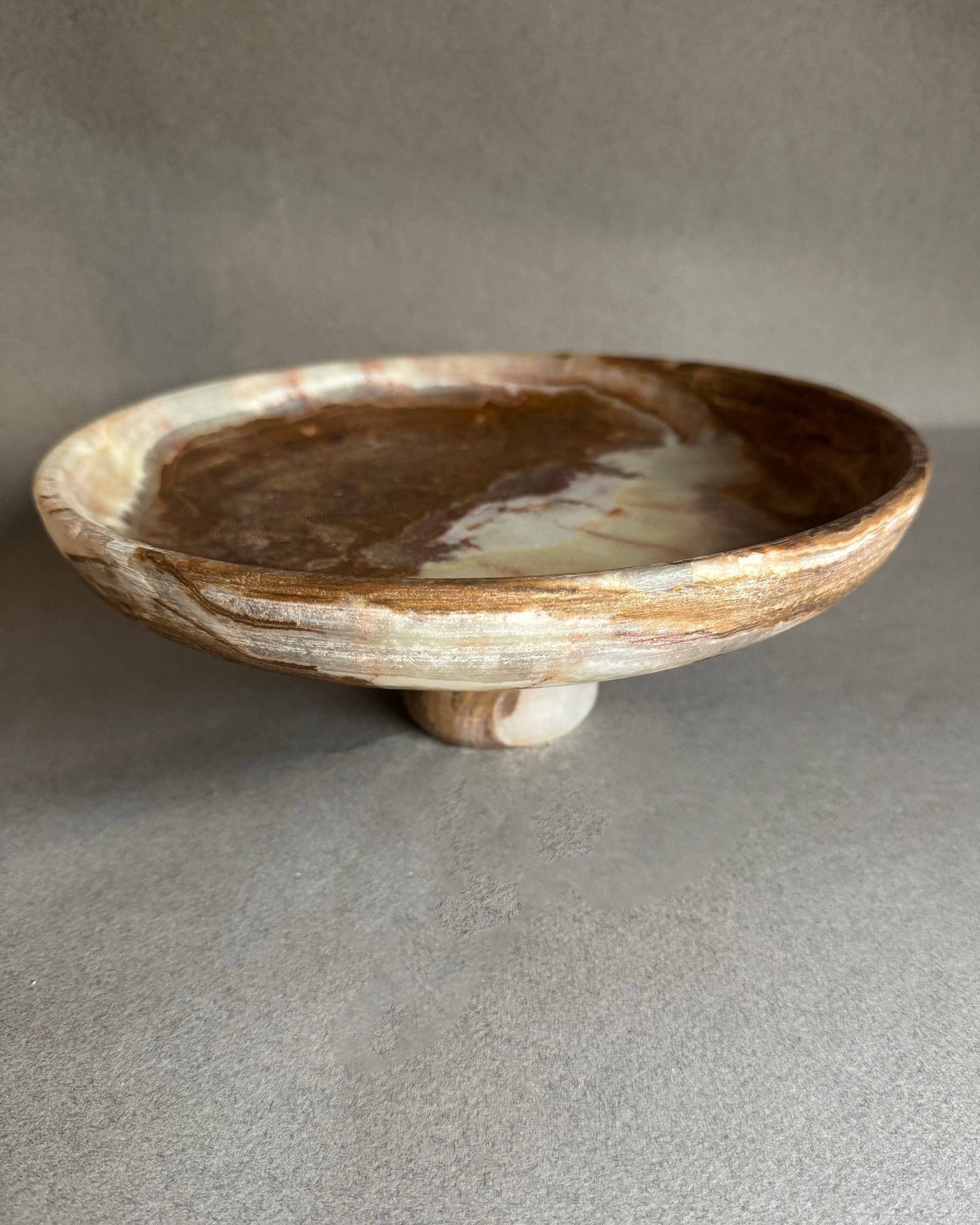 Stoneware bowl with a textured surface on a gray background