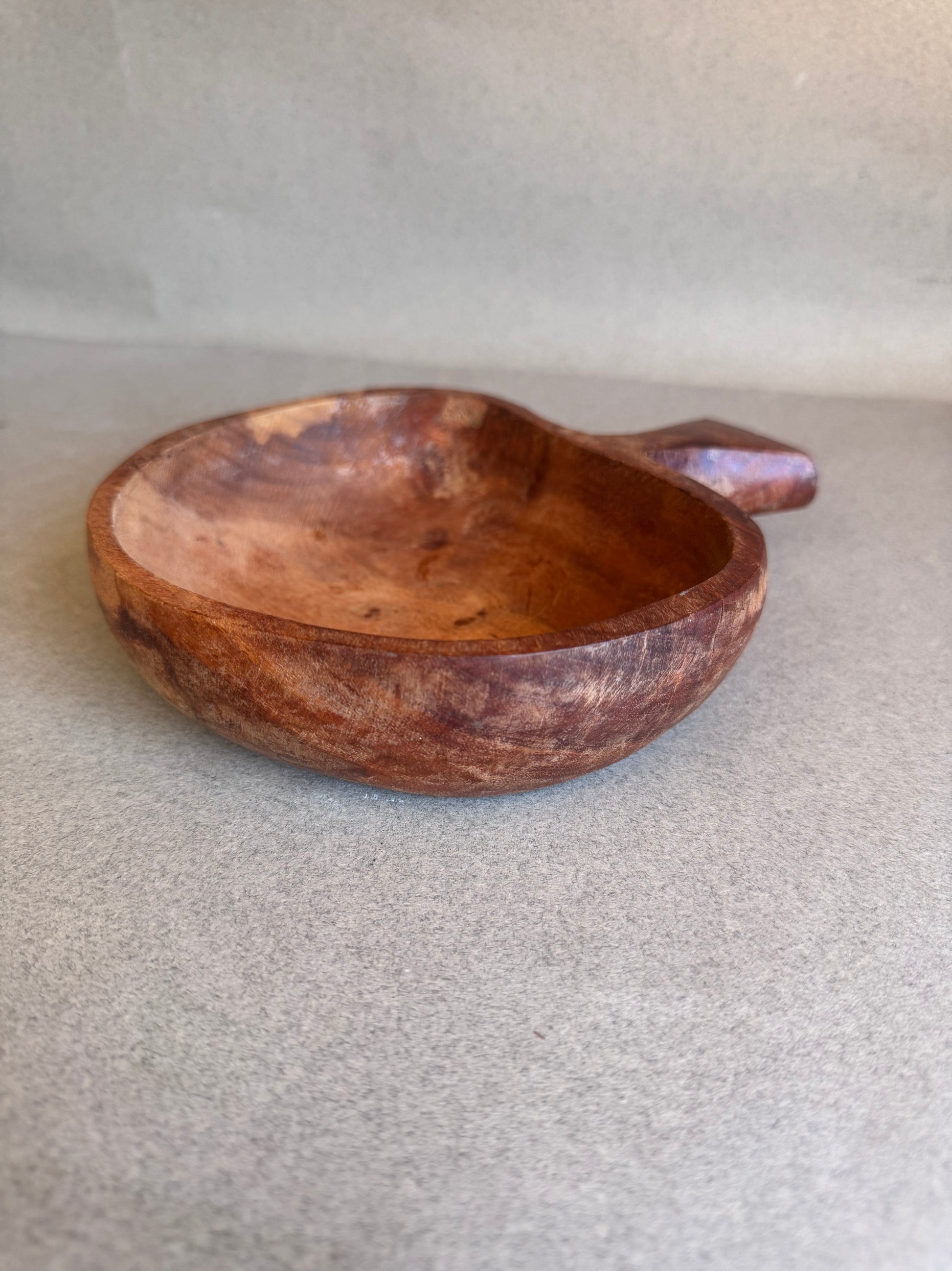 Wooden bowl on a light gray background