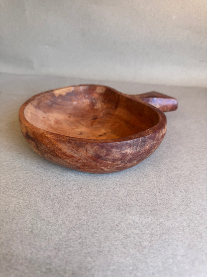 Wooden bowl on a light gray background