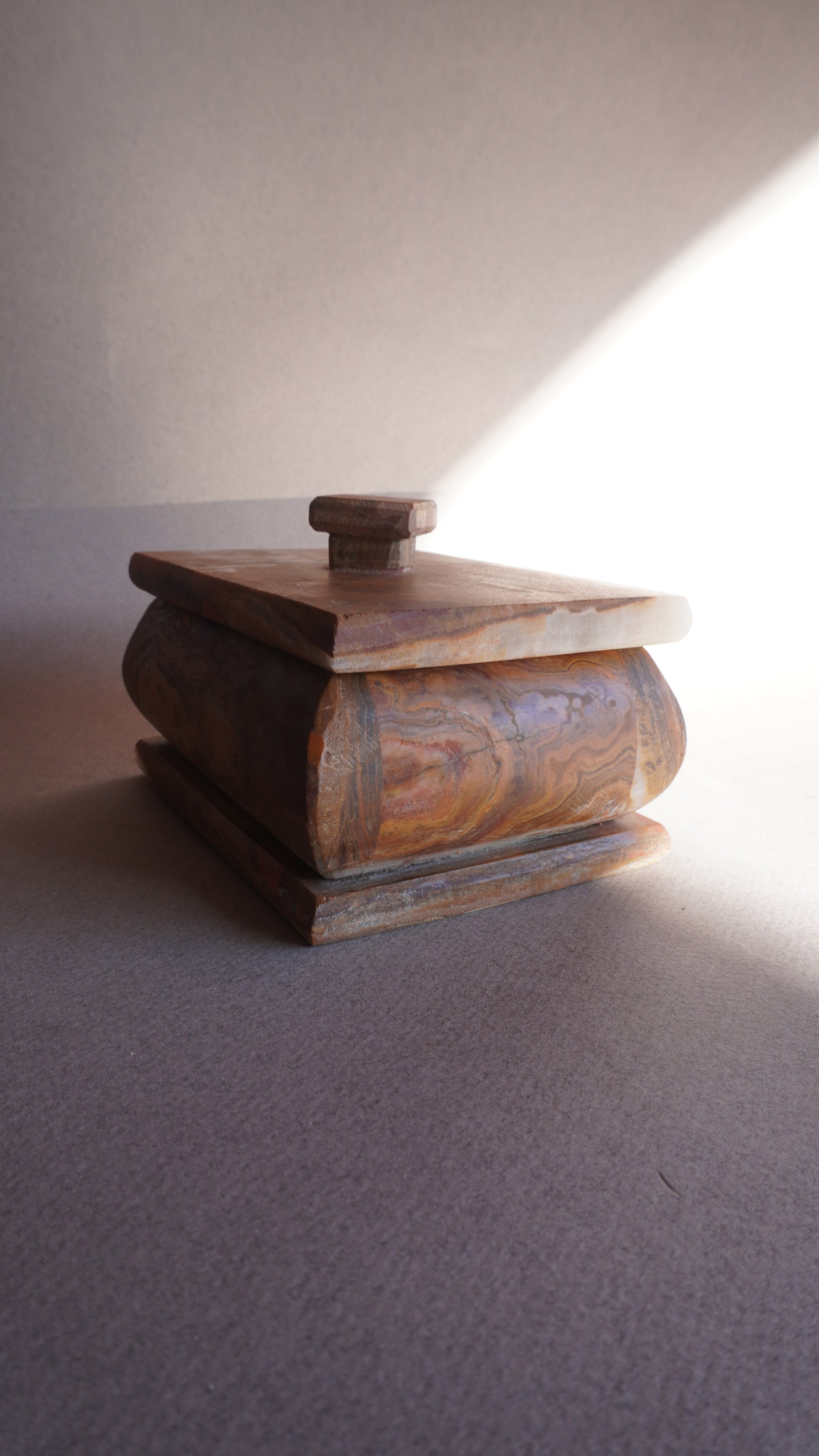 Stone keepsake box with lid set aside, ideal for storing jewelry, bath salts, or spices  
