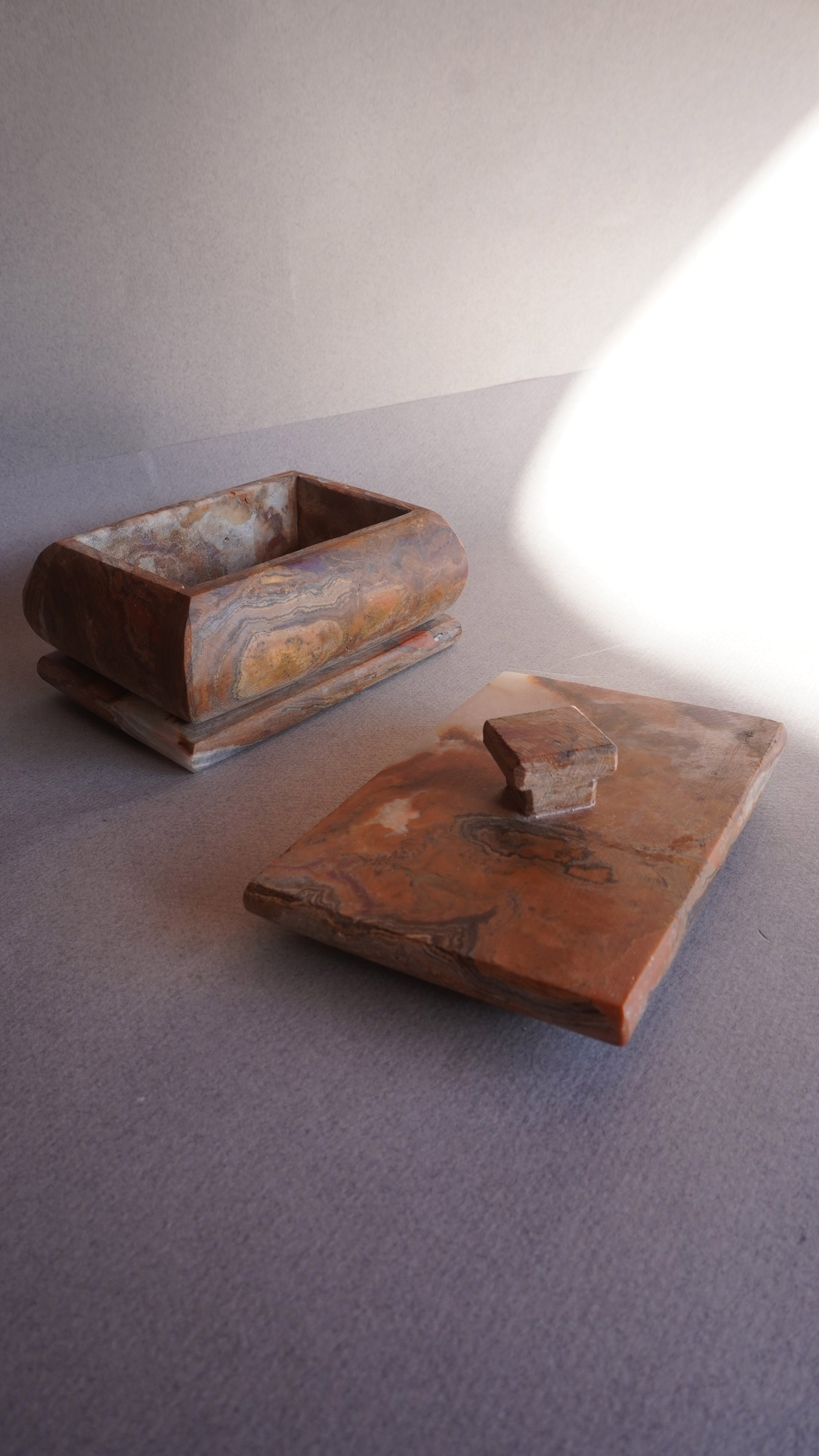 Stone keepsake box with lid set aside, ideal for storing jewelry, bath salts, or spices  
