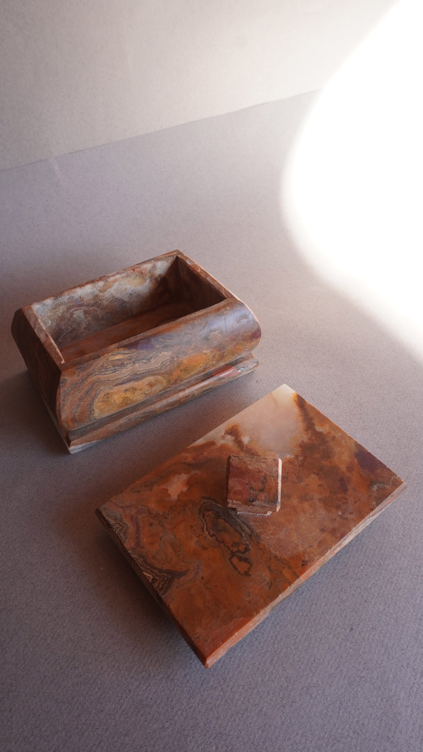 Handmade rectangular onyx box with lid removed, used as jewelry storage container  
