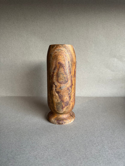 Earth-toned onyx vase with striated veining and rounded base
