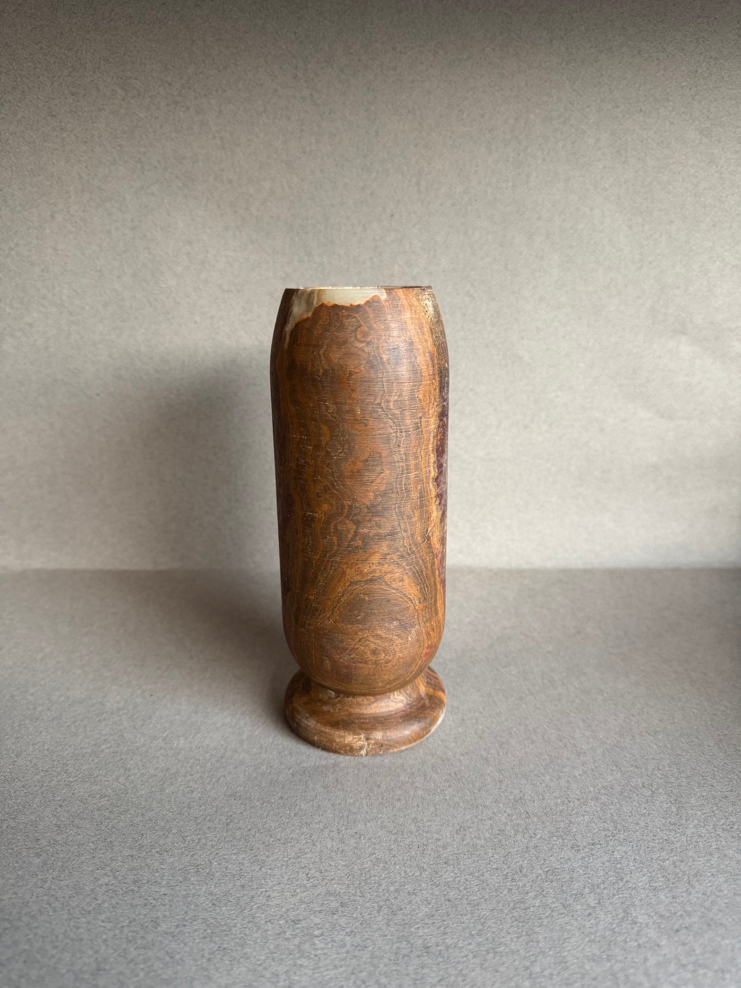 Sculptural tall vase with warm mineral layers in red and brown