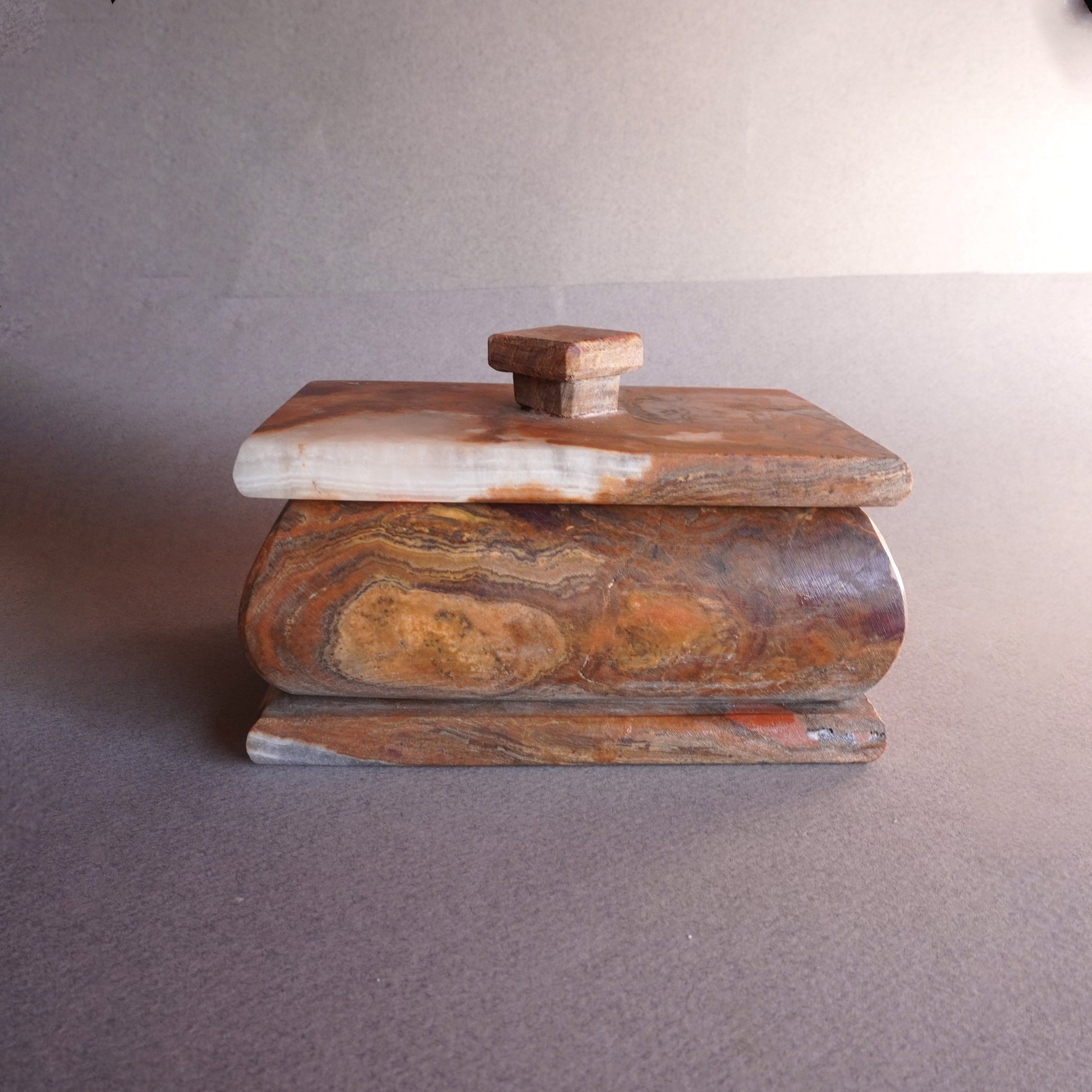 Hand-carved onyx keepsake box in mocha, sandstone, and copper tones with fitted lid  
