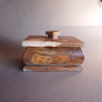 Hand-carved onyx keepsake box in mocha, sandstone, and copper tones with fitted lid  
