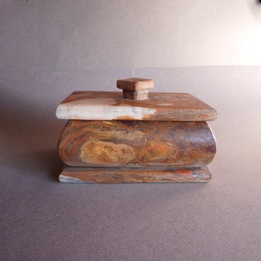 Hand-carved onyx keepsake box in mocha, sandstone, and copper tones with fitted lid  
