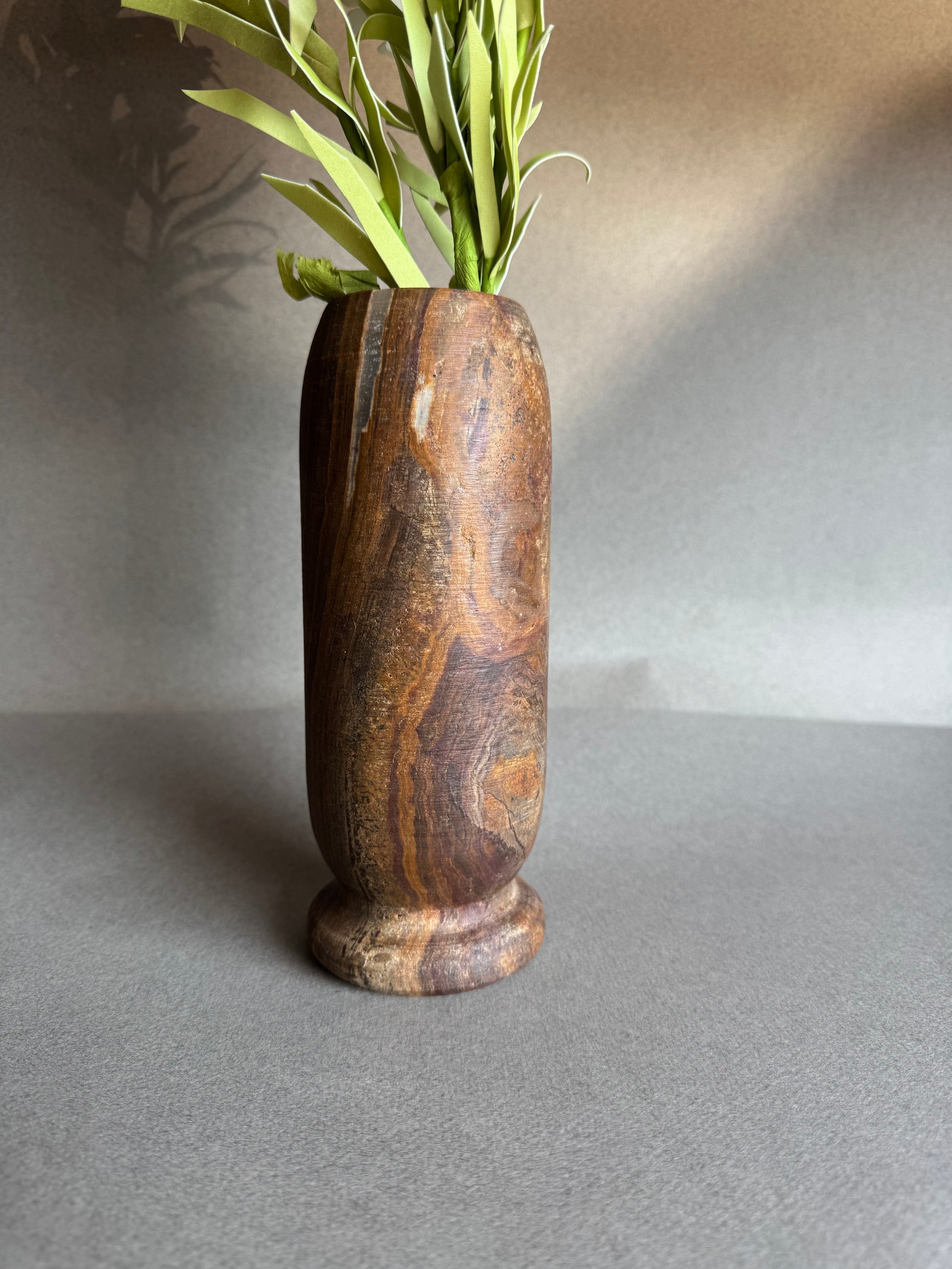 Natural stone vase in golden sand and deep brown tones

