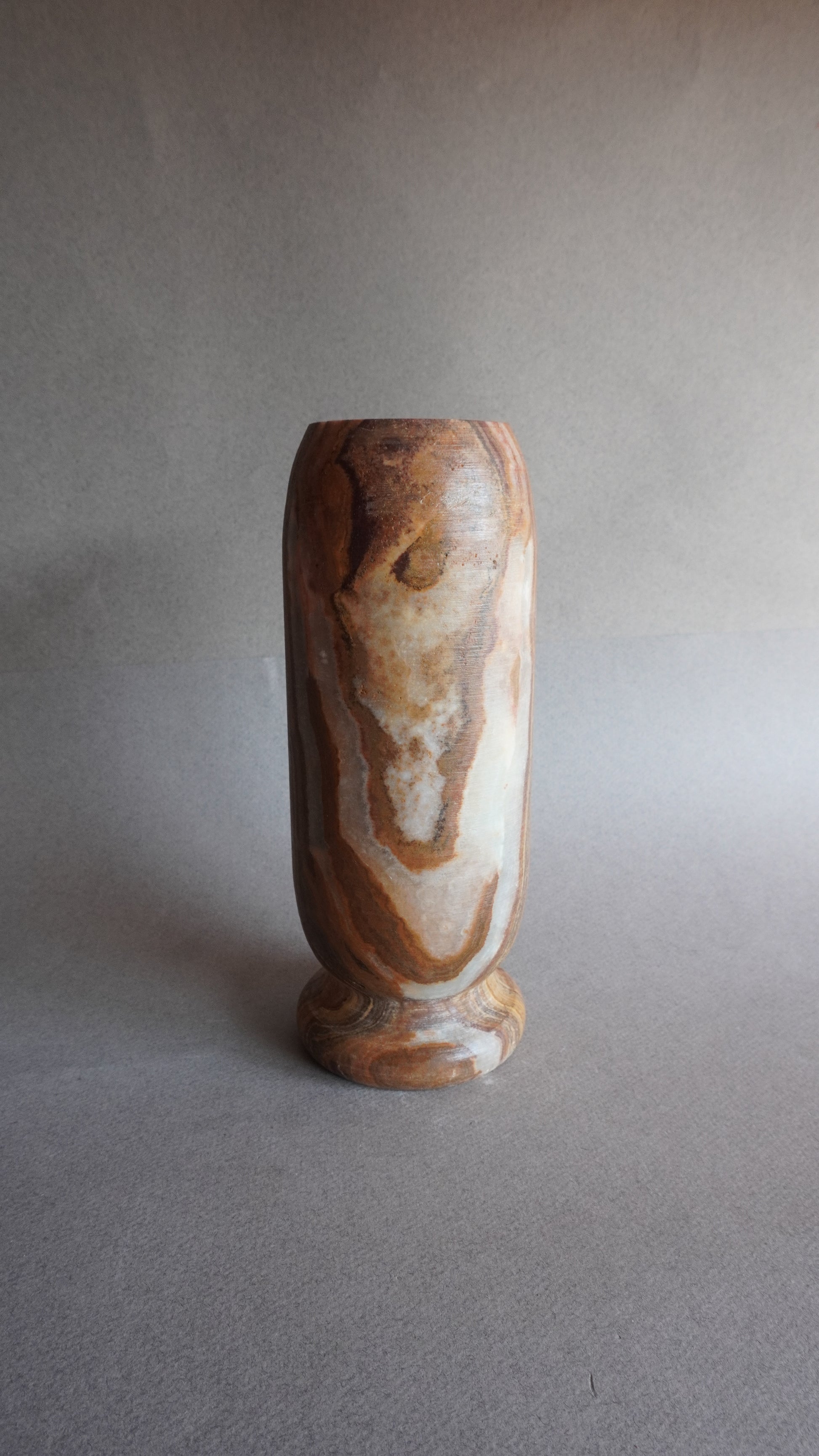 Decorative object with a brown and white pattern on a gray background