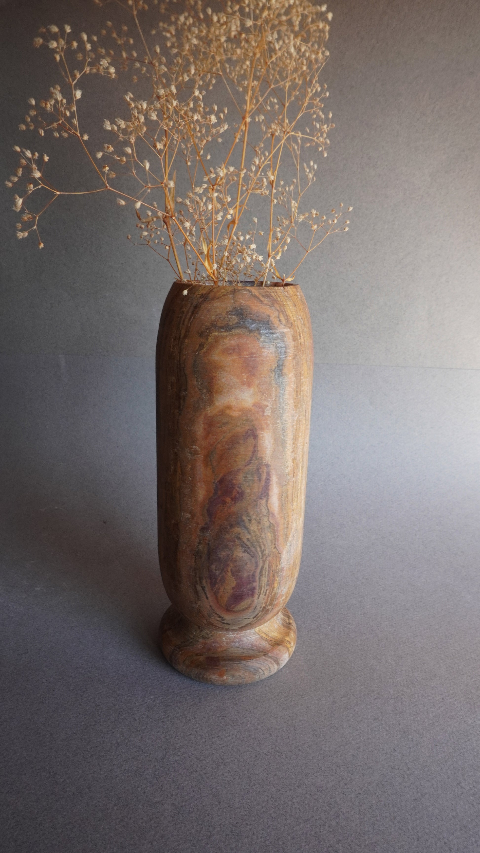 Handmade onyx vase with earthy brown and golden veining, tall stone centerpiece for organic modern interiors

