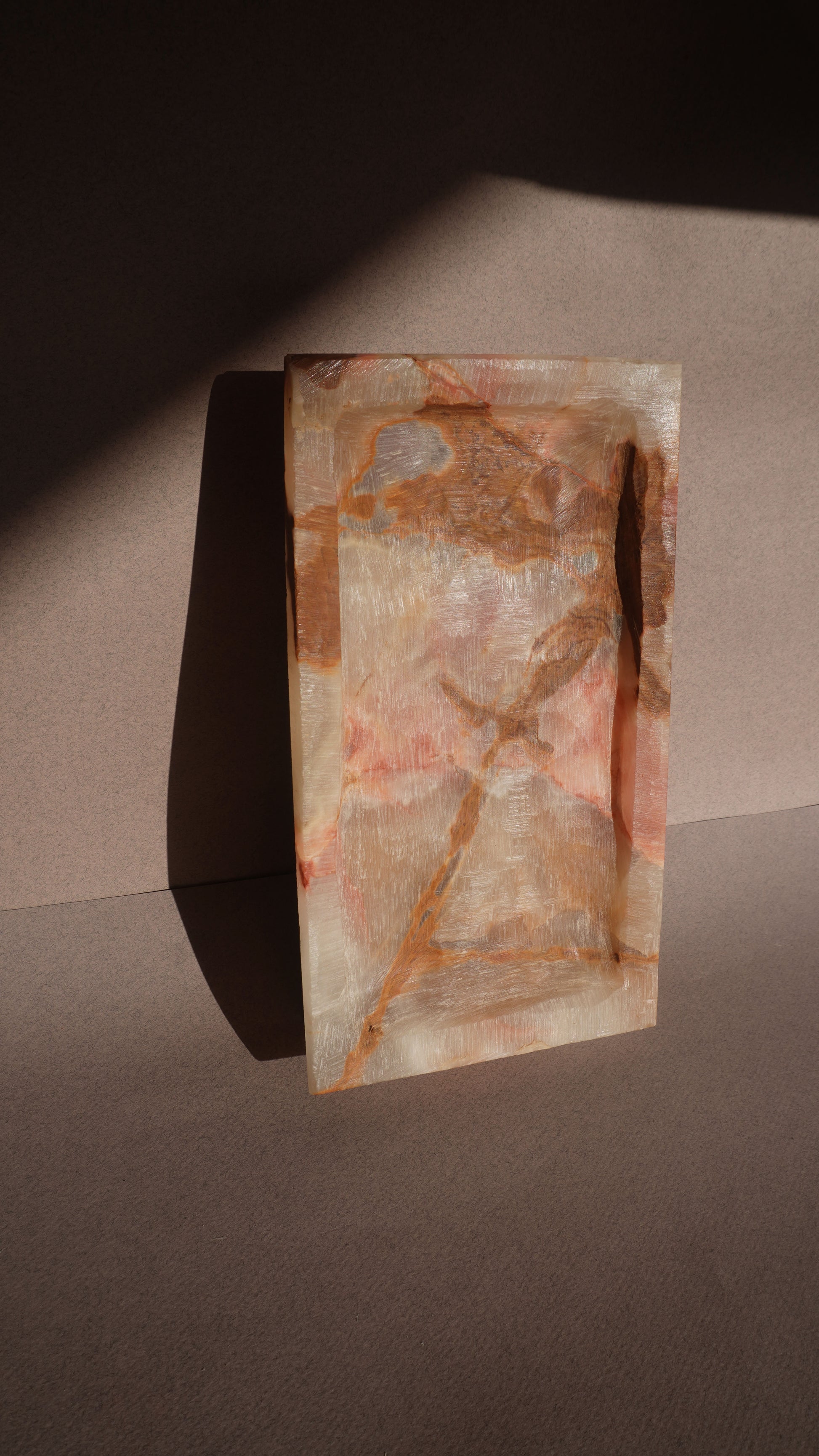 Decorative stone tray with natural patterns on a dark surface