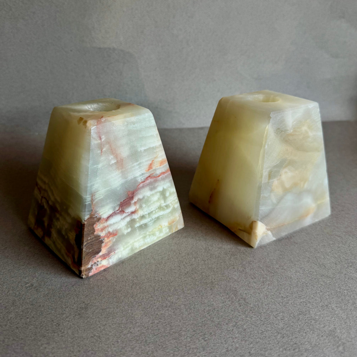 Earth-toned candle holders made from raw onyx, designed in California

