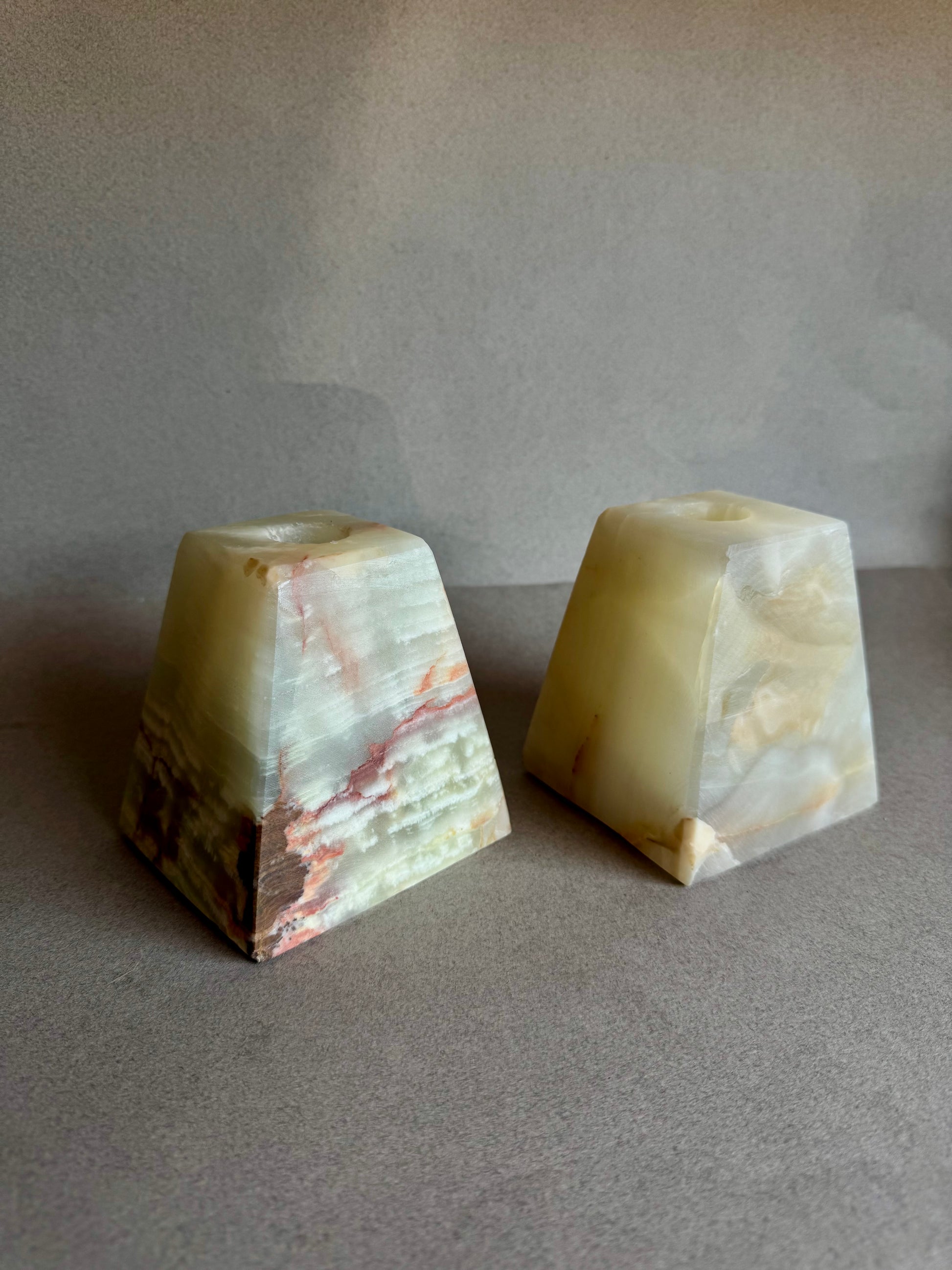 Earth-toned candle holders made from raw onyx, designed in California

