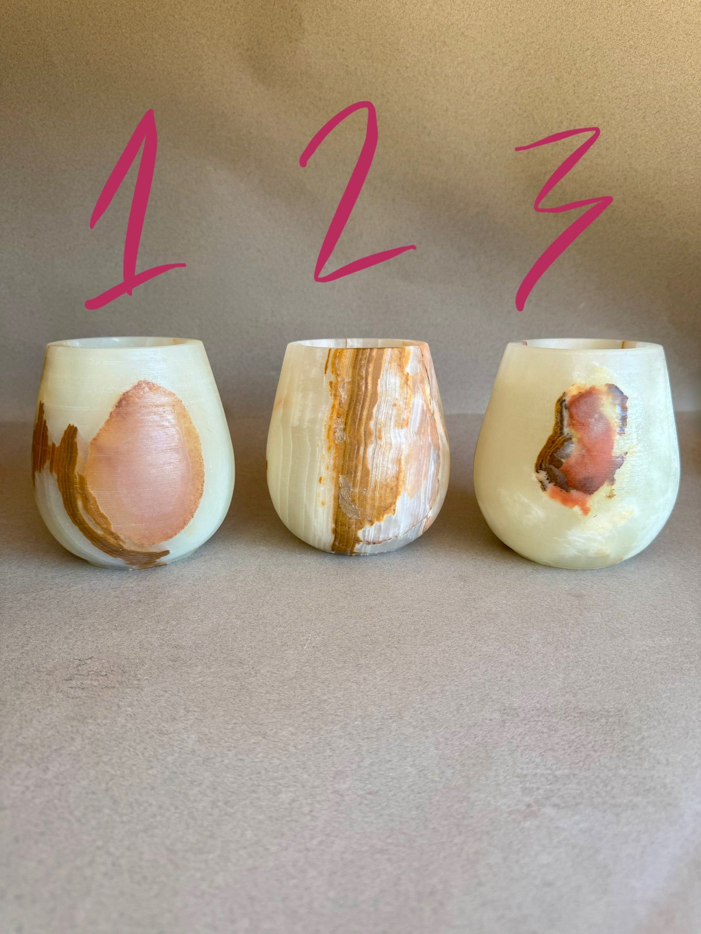Three pink onyx vessels with natural patterns on a beige background, labeled 1, 2, and 3.