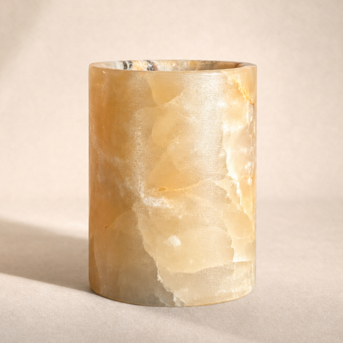 Marble-textured cylindrical jar on a neutral background