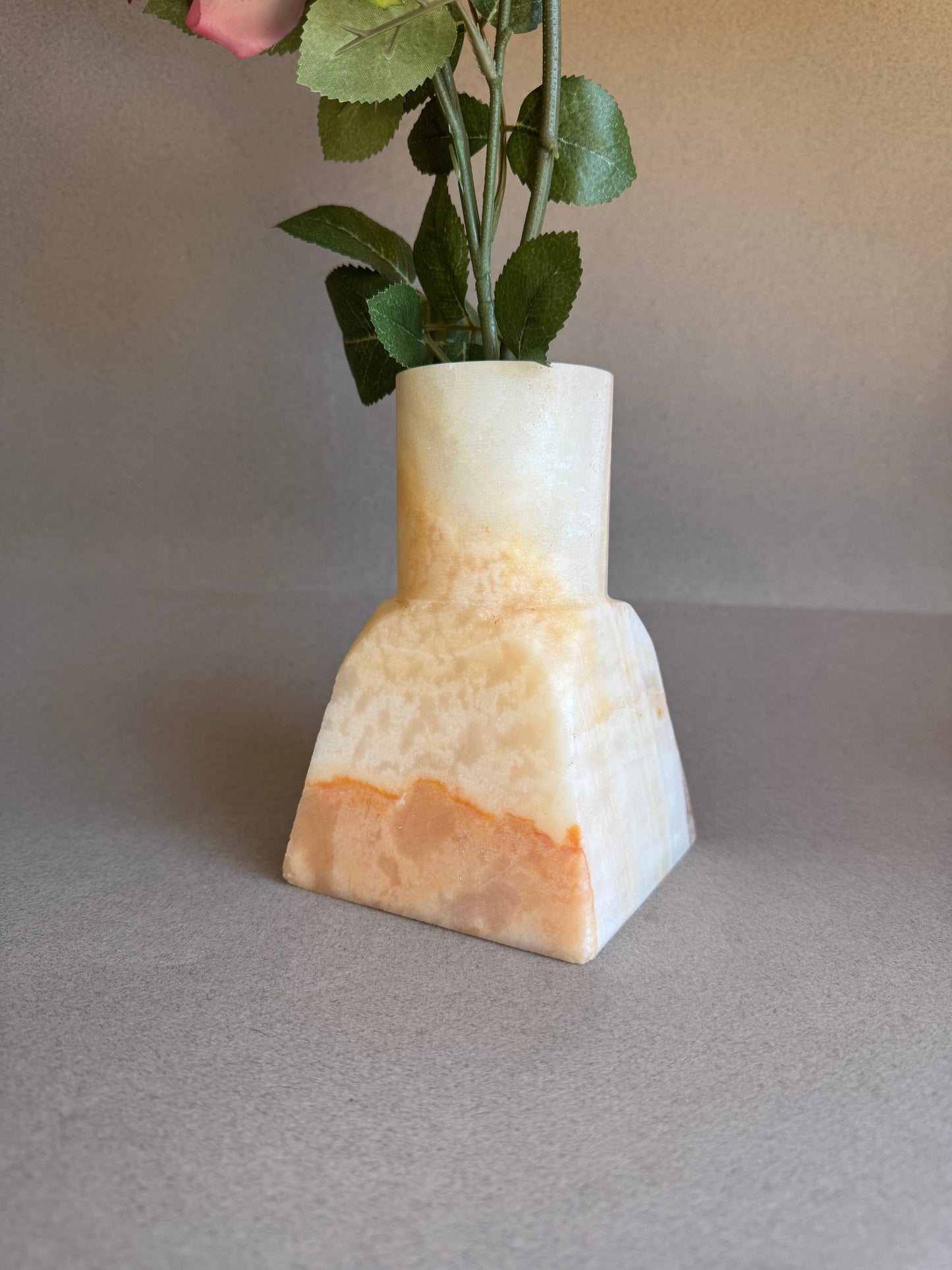 pink onyx  Decorative vase with a geometric design on a plain background