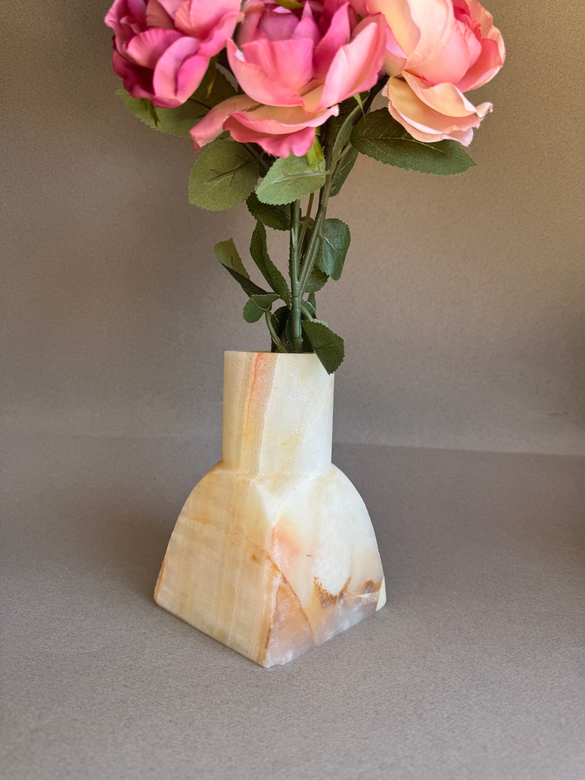 pink onyx  Decorative vase with pink flowers on a neutral background
