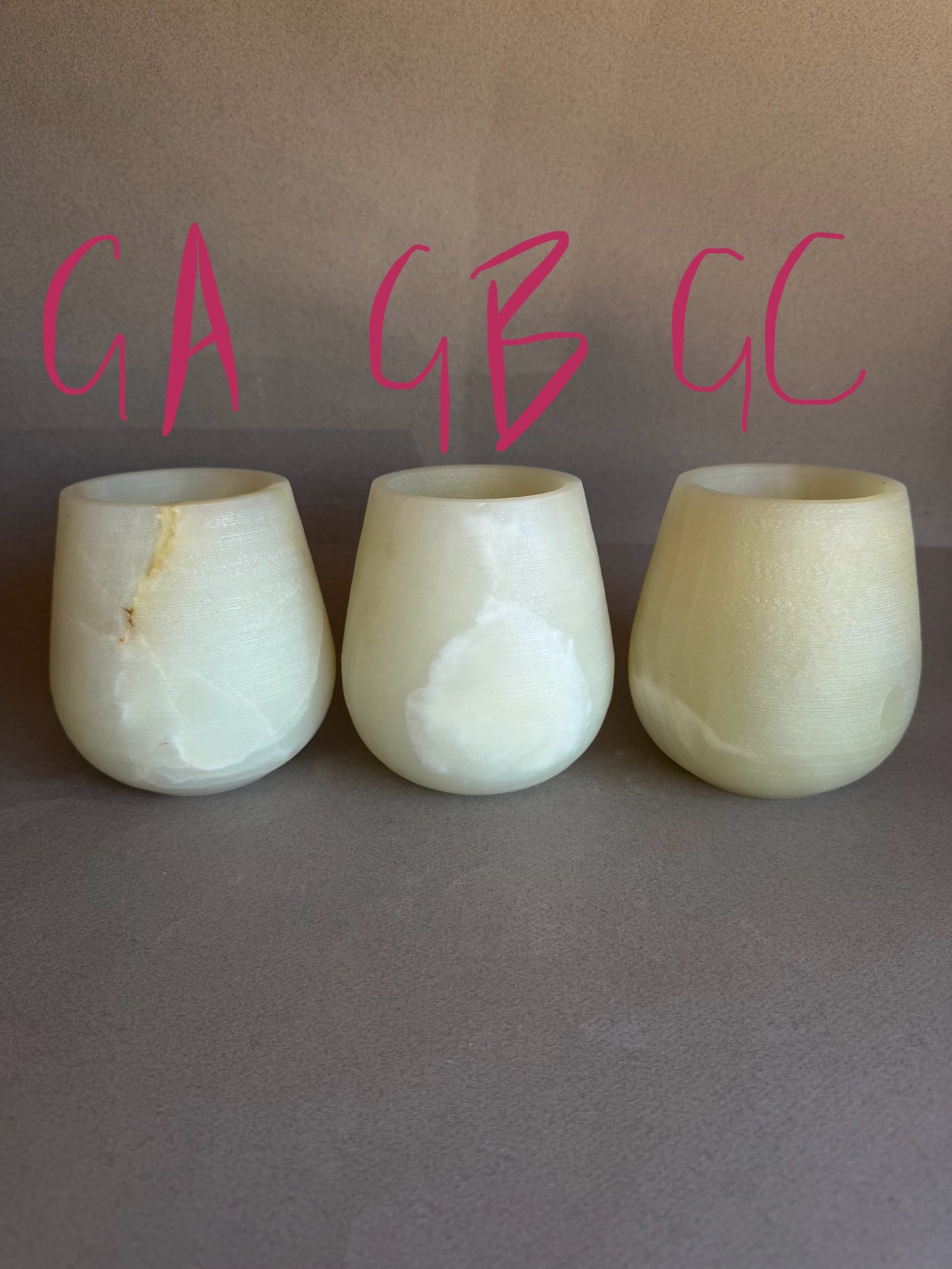 Three light green onyx stone labeled GA, GB, and GC on a gray background