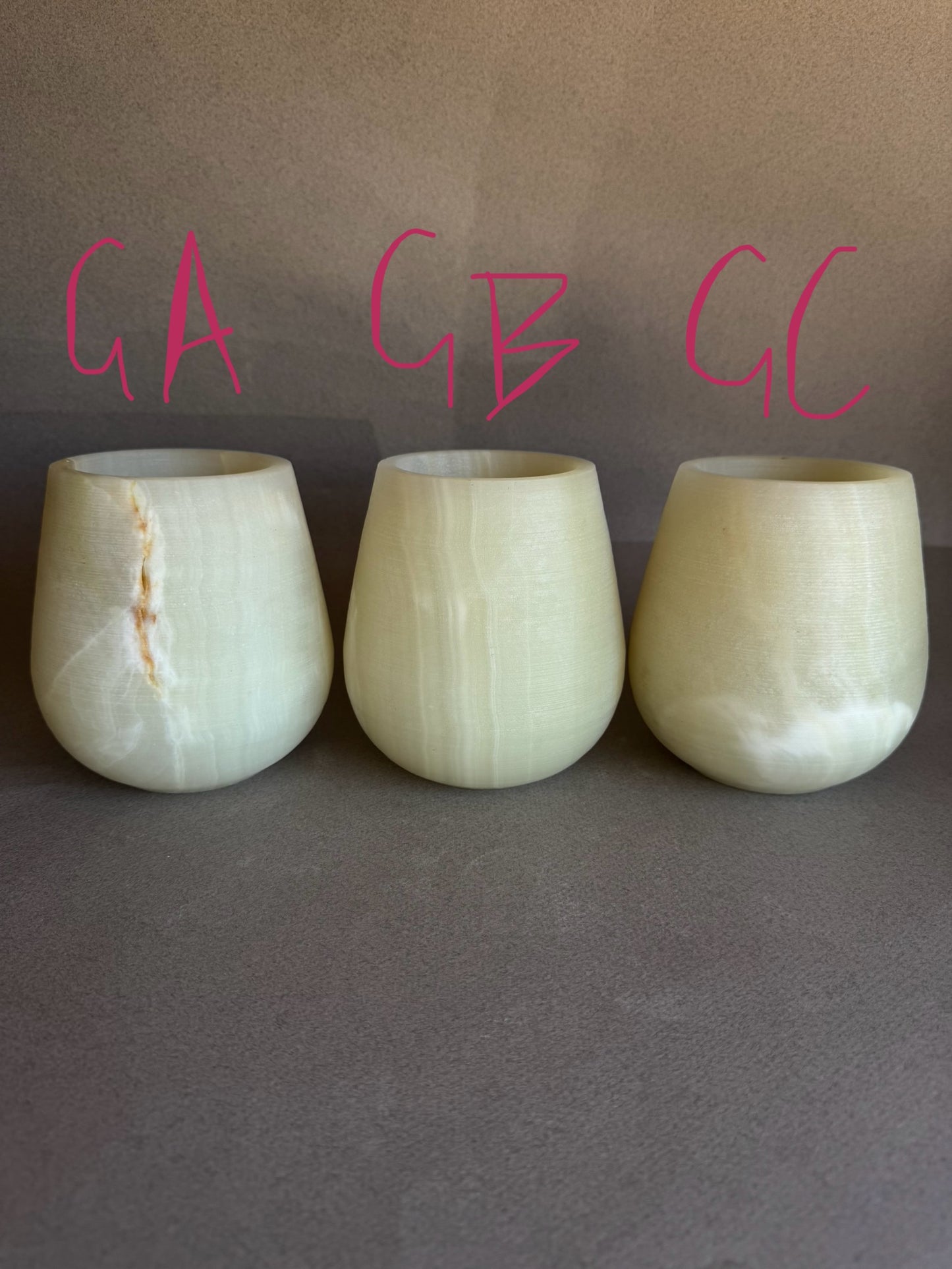 Three light green onyx vessels labeled GA, GB, GC on a gray background