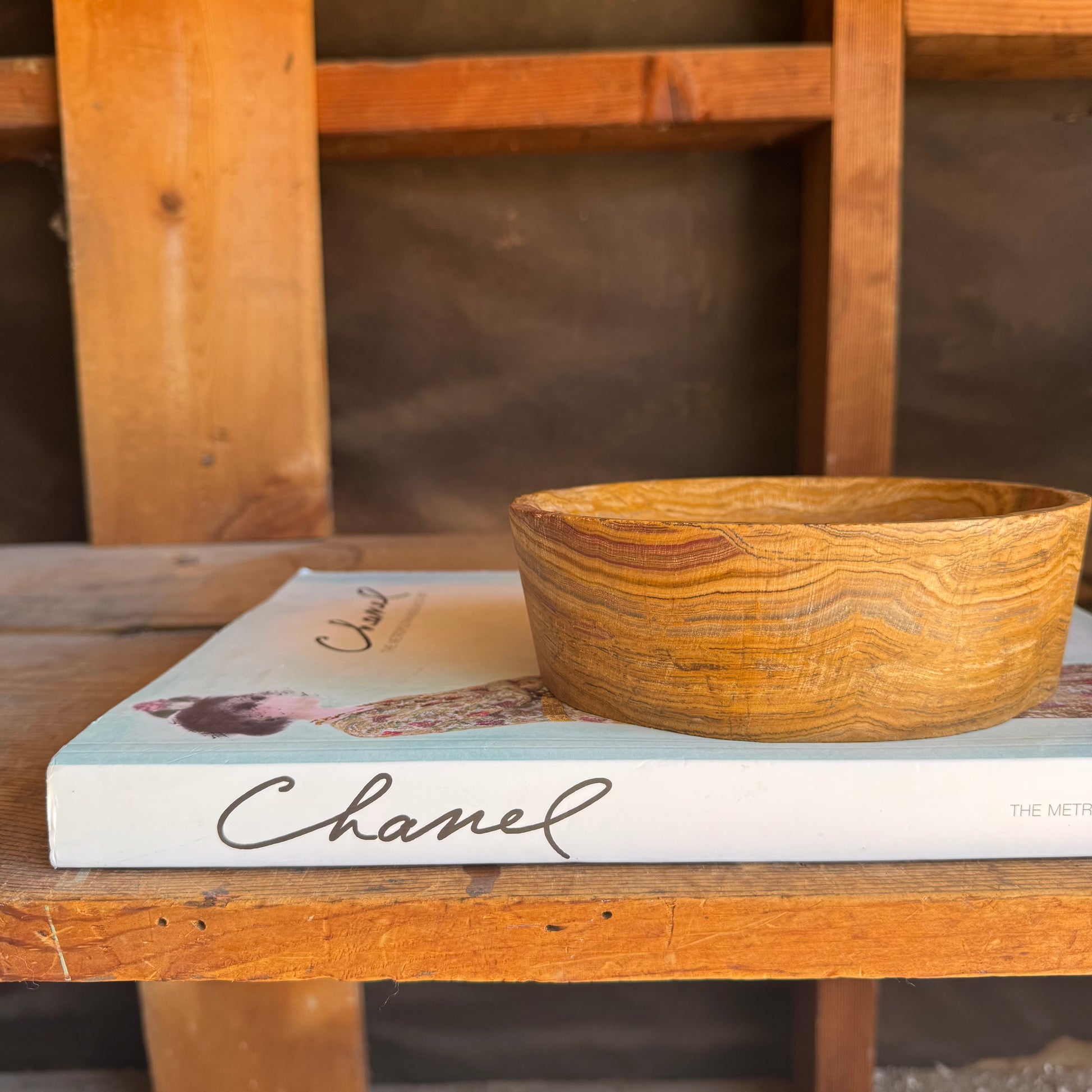 Side profile of onyx bowl showing deep striations in clay, rosewood, and ochre

