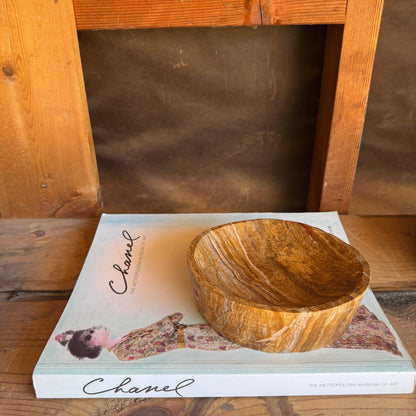 Top-down view of compact onyx bowl showing fine linear veining in golden and honey tones