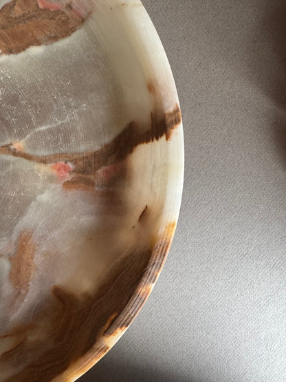 SAÉA onyx bowl styled on a table, demonstrating its use as a centerpiece in a minimalist, earthy interior

