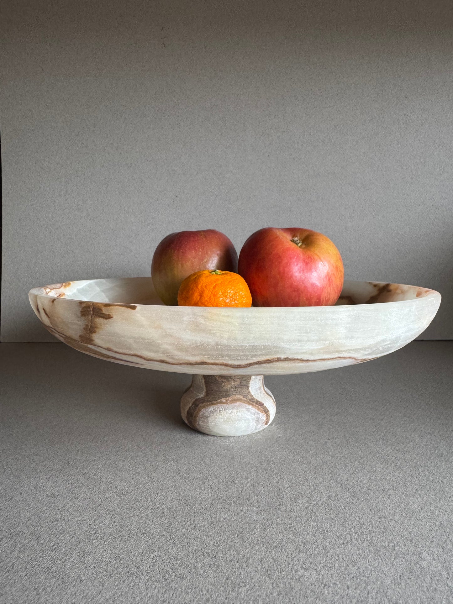 SAÉA onyx bowl used as a minimalist centerpiece fruit bowl in an earthy, calming interior