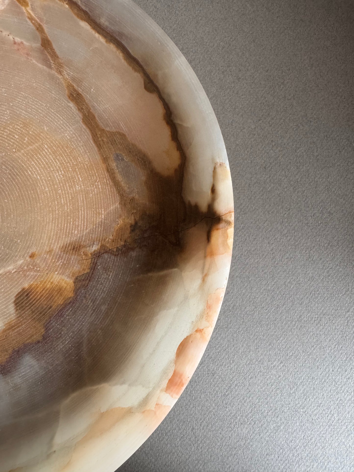 Back angle of hand-carved pedestal bowl, showing elevated base and smooth texture