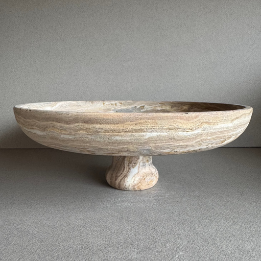 Hand-carved onyx vase in soft walnut, blush, and ivory tones with cylindrical form and pedestal base.

