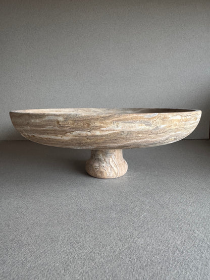 Top view of sculptural onyx bowl with swirling brown, beige, and gray marbling

