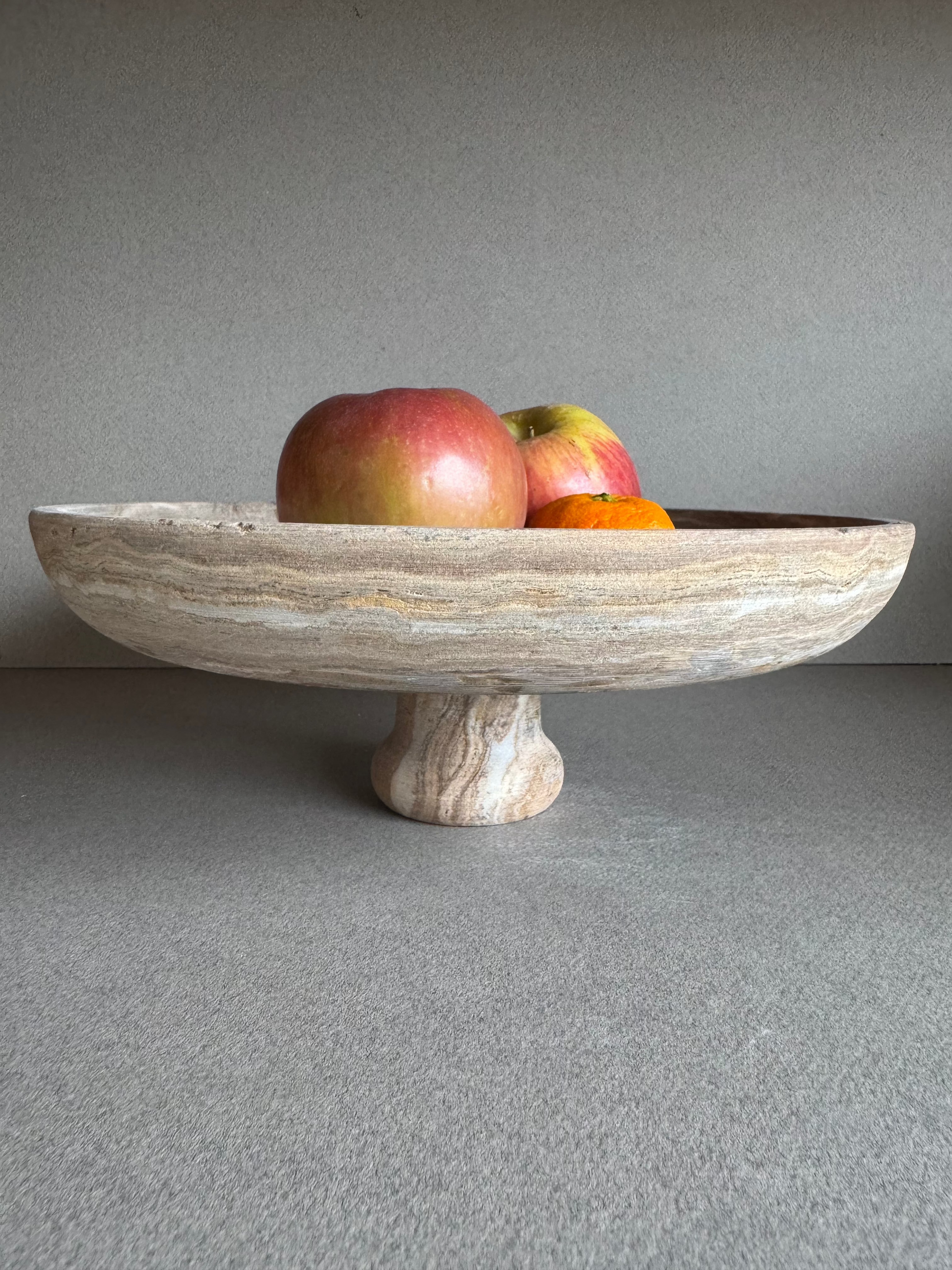 SAÉA onyx pedestal bowl styled as a centerpiece with moody natural lighting and organic textures

