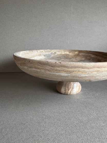 Minimalist interior scene with SAÉA pedestal bowl in warm brown and taupe veining


