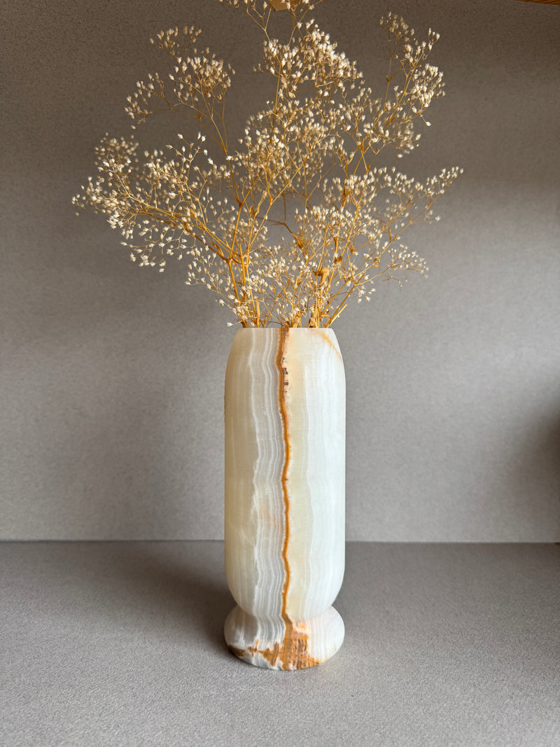 Vase styled with dried baby’s breath, emphasizing minimalist, sculptural form.

