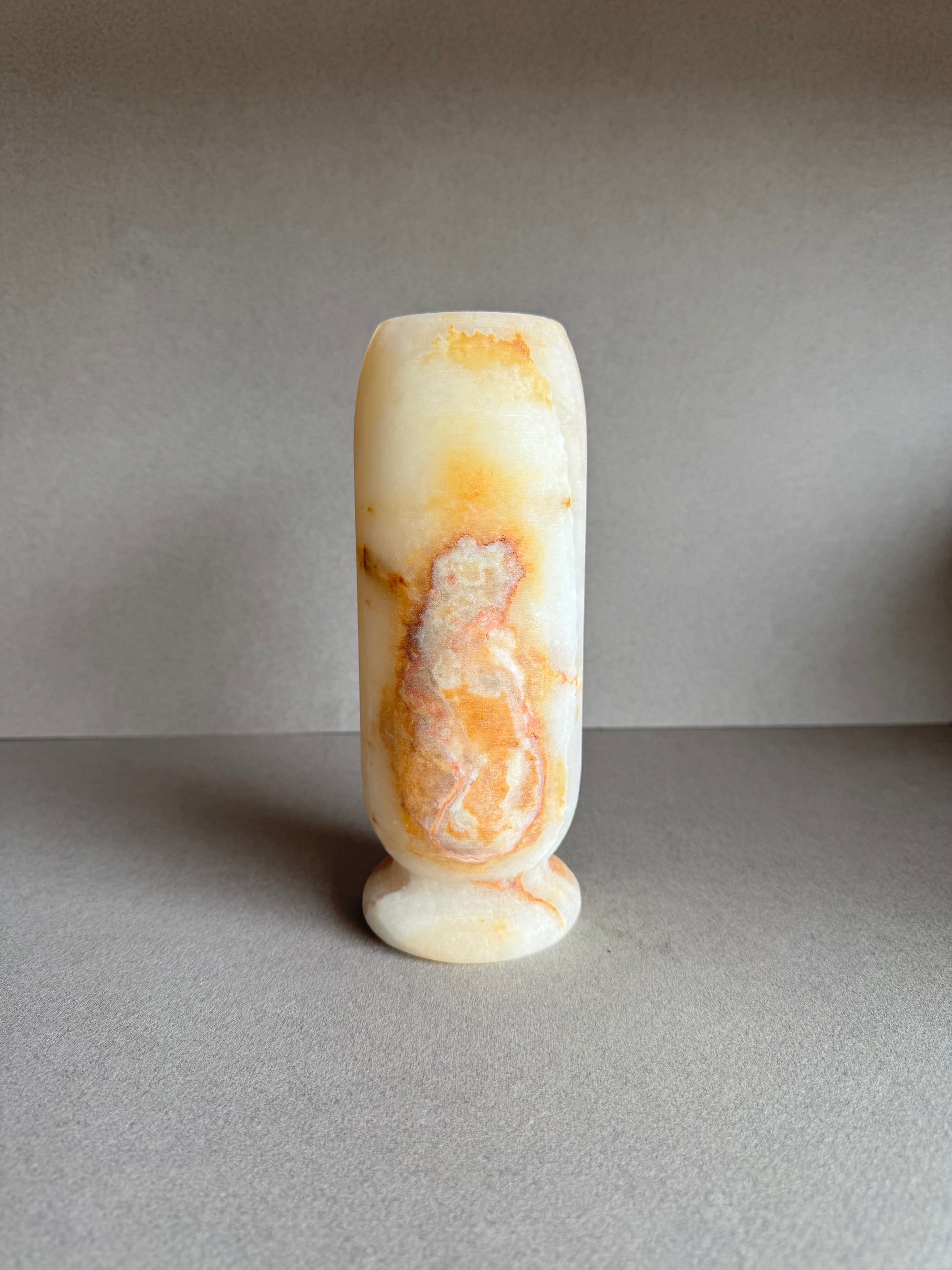 Profile angle highlighting subtle white-on-gold marbling and soft matte finish.
