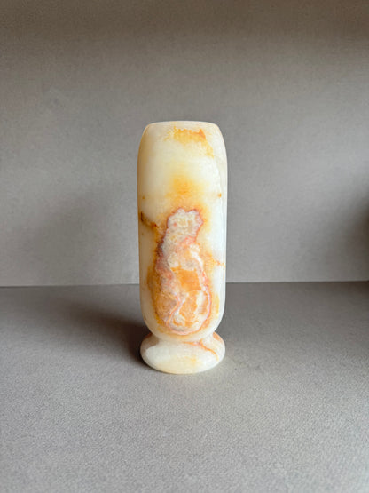 Profile angle highlighting subtle white-on-gold marbling and soft matte finish.
