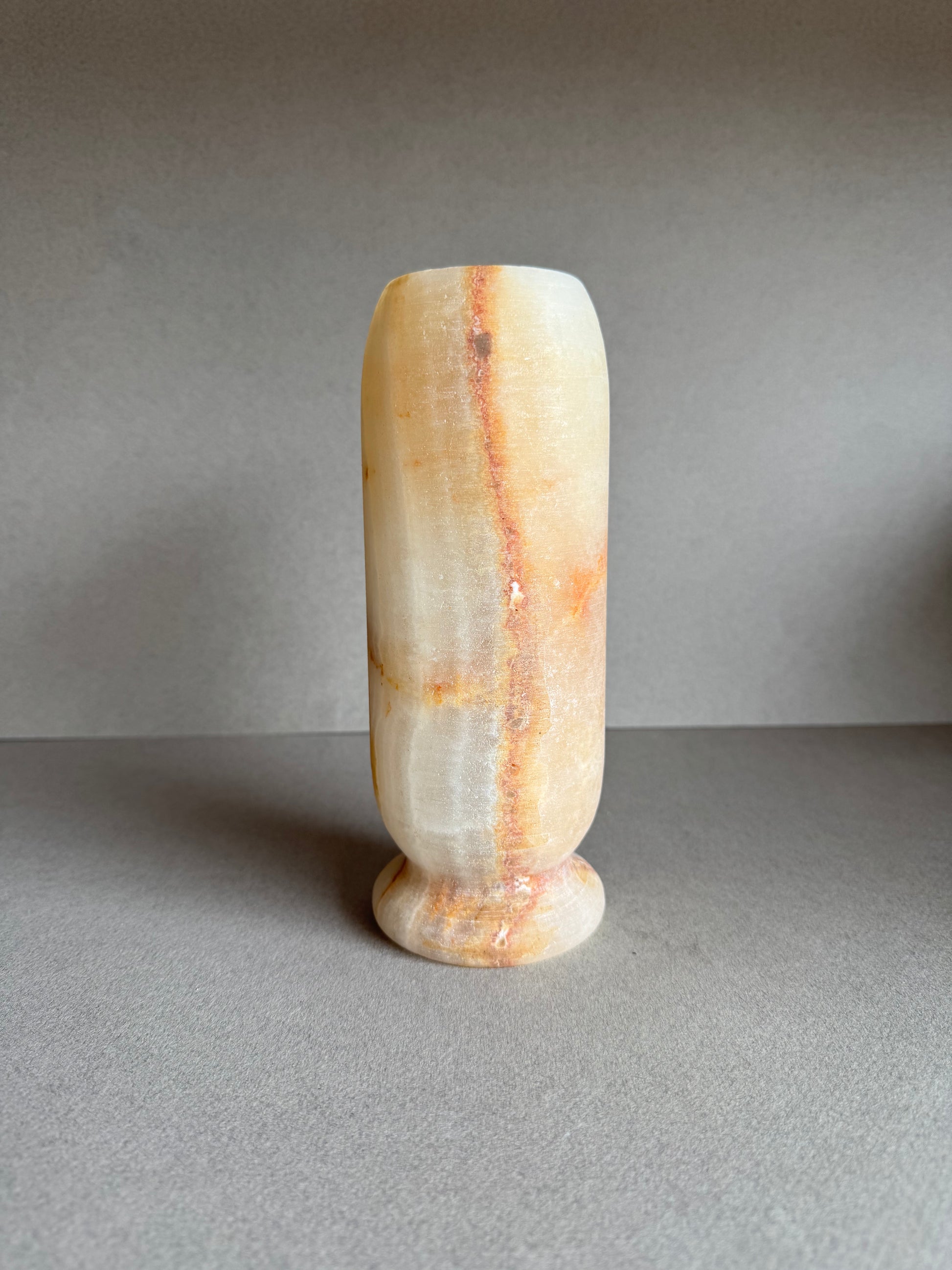Profile angle highlighting subtle white-on-gold marbling and soft matte finish.

