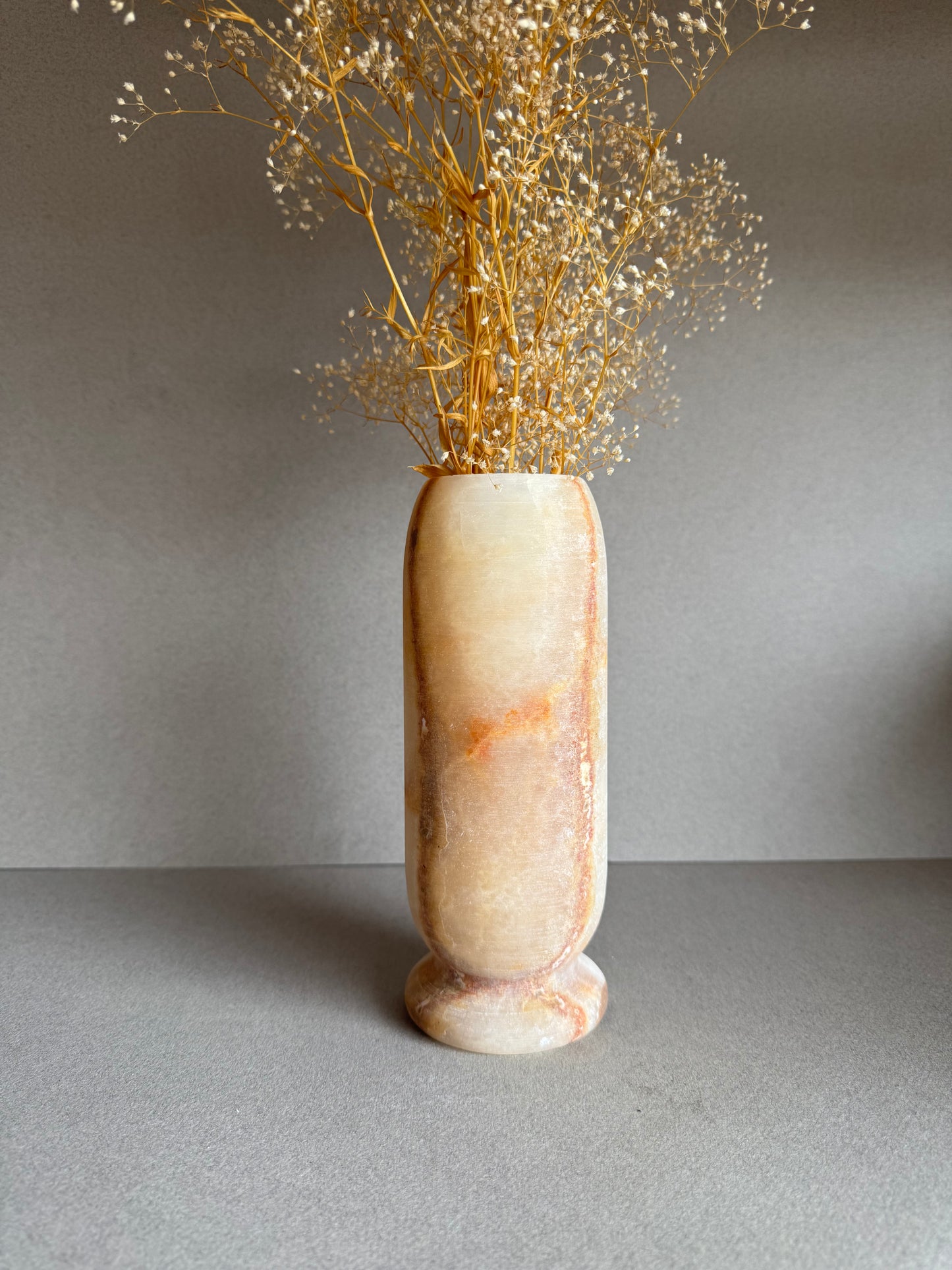 Full vase with florals, showcasing radiant peach and amber coloring.

