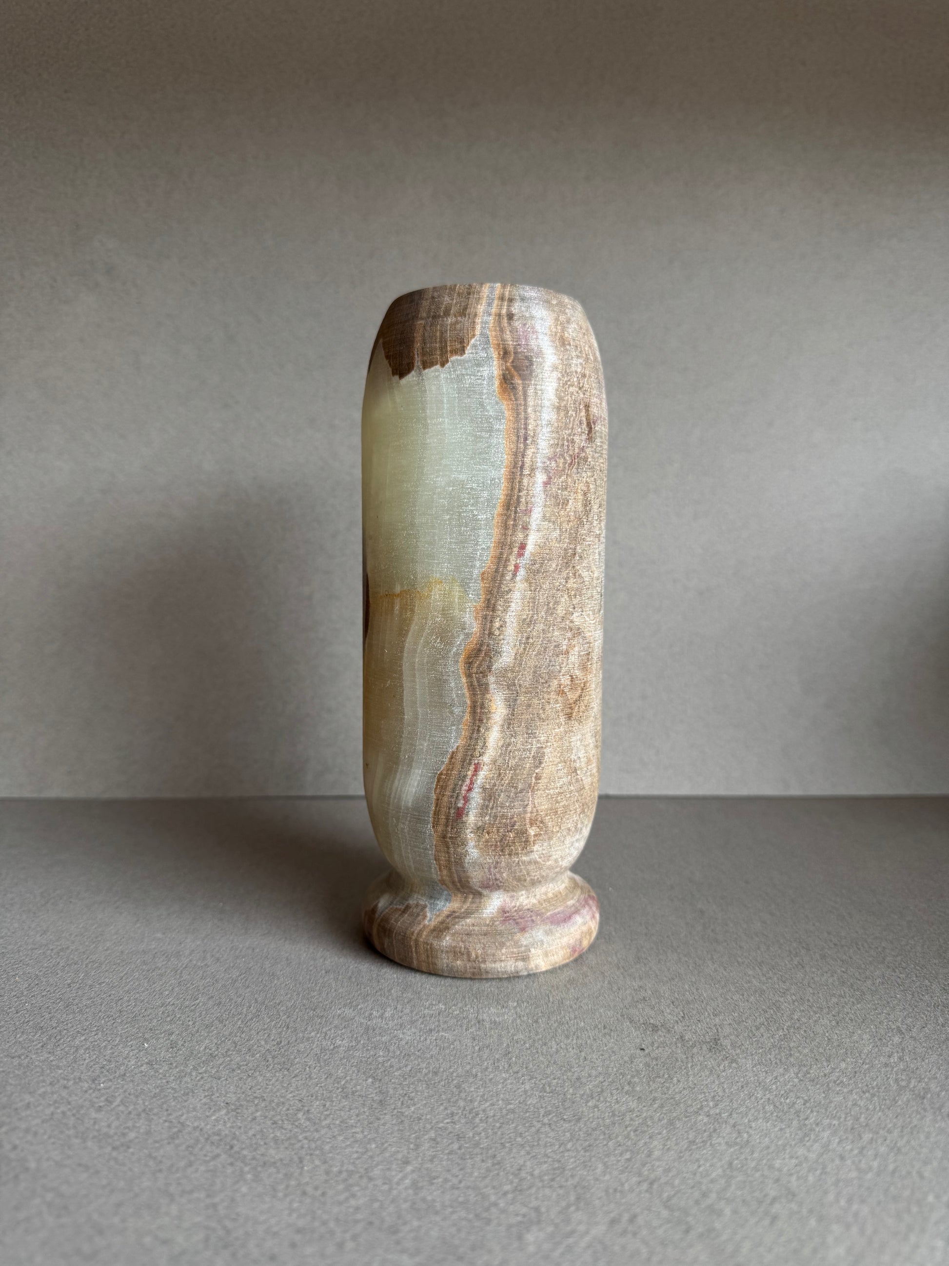 Profile view of vase featuring a warm transition from smoky brown to pale rose tones.

