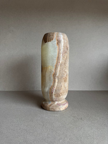 Profile view of vase featuring a warm transition from smoky brown to pale rose tones.

