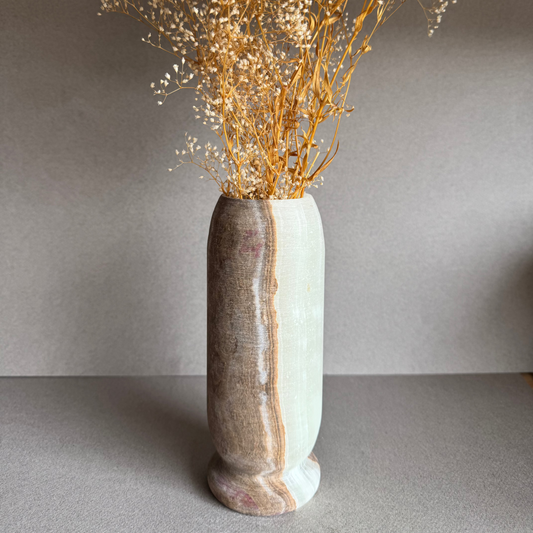 Vase styled with dried baby’s breath florals, standing tall against a neutral backdrop.

