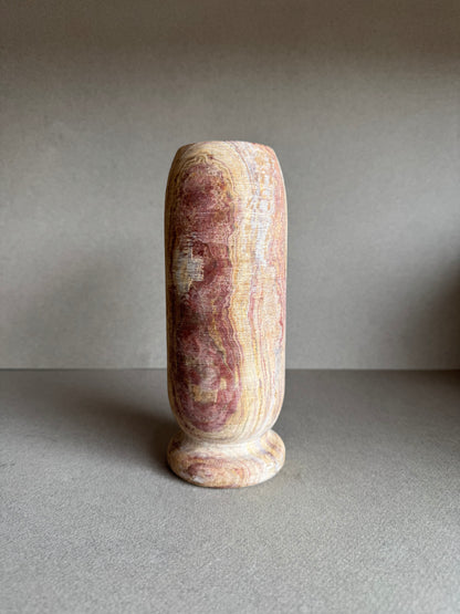 Front angle of tall vase showing clay and blush banding with natural onyx character.

