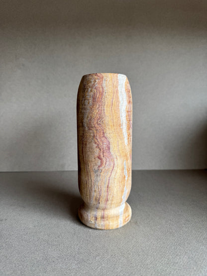 Rear profile with bold rose marbling and textured mineral surface.

