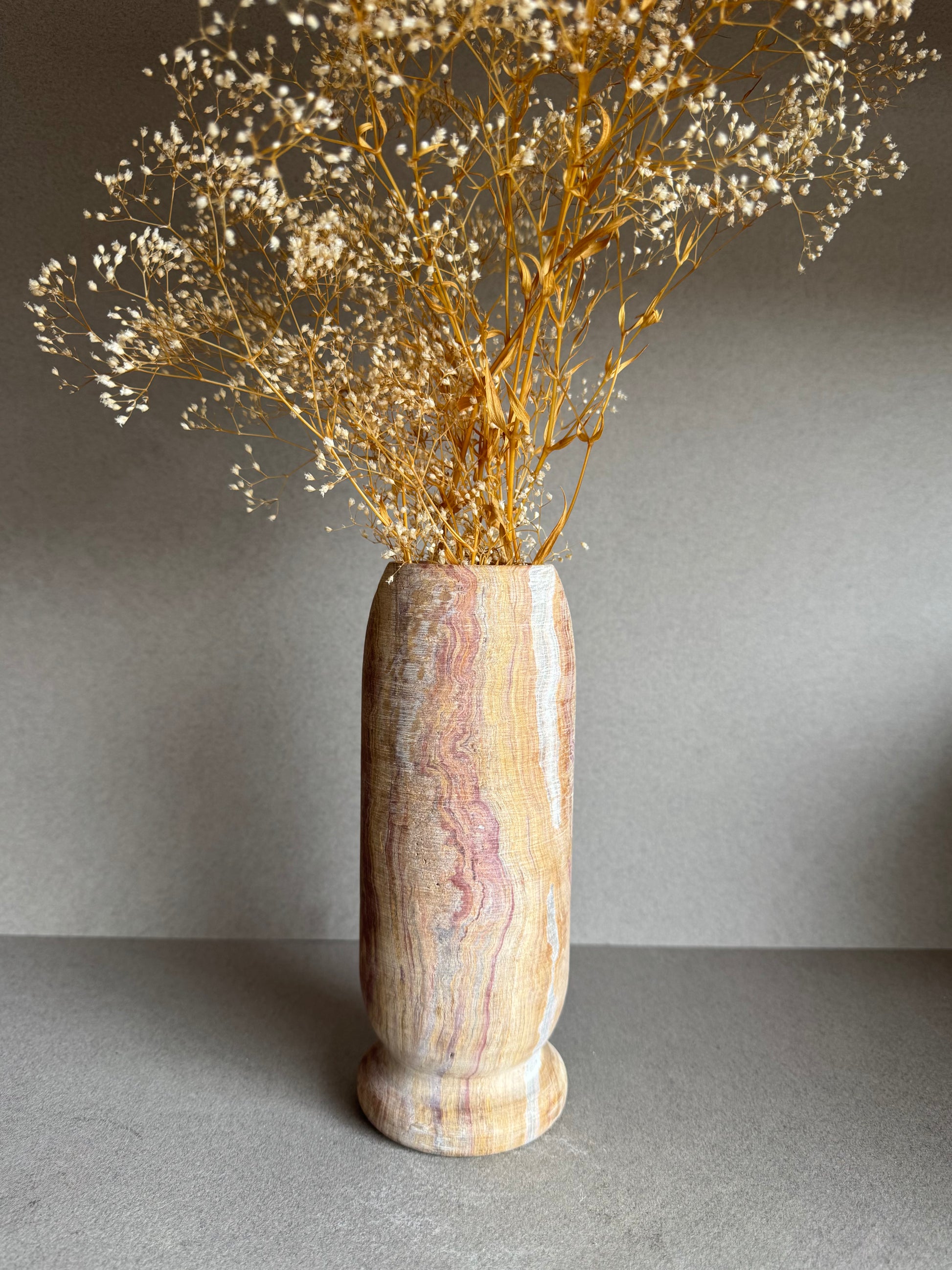 Floral-styled shot showing veining across warm sandstone hues and minimalist design.

