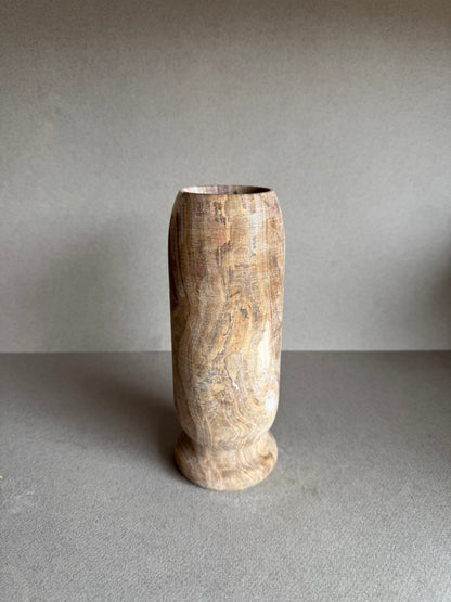 Back view of the stone vase showing layered beige and rust veining with subtle texture.

