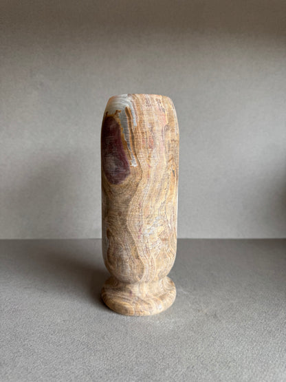 Front angle with visible marbling in soft blush and stone-white hues.

