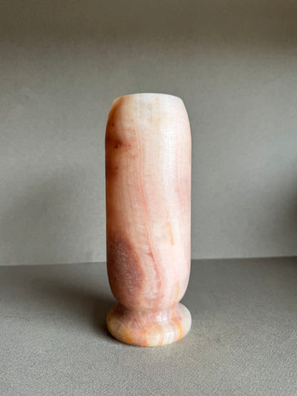 Cylindrical vase with smooth matte finish and softly blended apricot and ivory veining.

