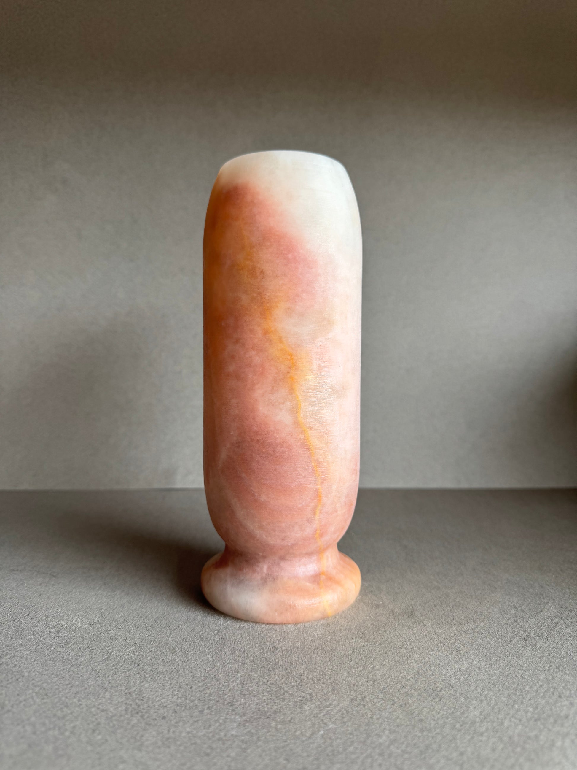 Full styled view of vase with gentle marbling in desert-inspired hues.

